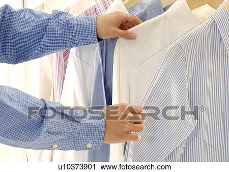 Cropped view of a person selecting the shirts. View Large Photo Image Stock Image - Cropped view of a person selecting the shirts.. Fotosearch