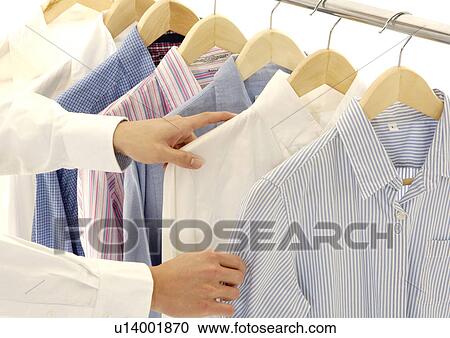Cropped view of a person selecting the shirts. View Large Photo Image Stock Image - Cropped view of a person selecting the shirts.. Fotosearch