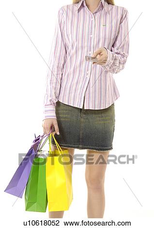 Cropped view of a young woman holding shopping bags. View Large Photo Image Stock Image - Cropped view of a young woman holding shopping bags.. Fotosearch