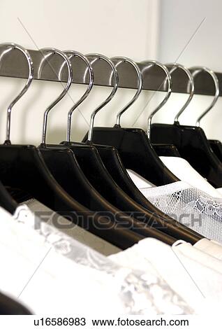 Cropped view of garments on hangers. View Large Photo Image Stock Image - Cropped view of garments on hangers.. Fotosearch