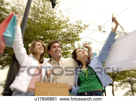 Three friends rejoicing after their shopping. View Large Photo Image Stock Image - Three friends rejoicing after their shopping.. Fotosearch