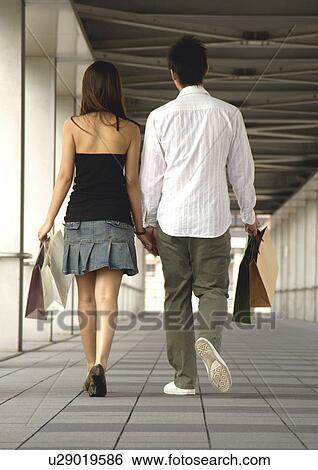 View of a couple shopping together. View Large Photo Image Stock Photograph - View of a couple shopping together.. Fotosearch