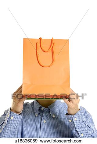View of a man holding a shopping bag in front of his face. View Large Photo Image Stock Photo - View of a man holding a shopping bag in front of his face.. Fotosearch