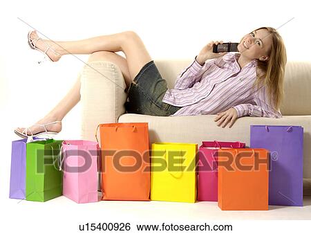 View of a woman lying on a couch. View Large Photo Image Stock Photograph - View of a woman lying on a couch.. Fotosearch
