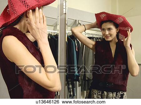 View of a woman posing in front of a mirror. View Large Photo Image Stock Photograph - View of a woman posing in front of a mirror.. Fotosearch