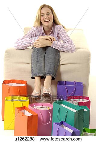 View of a young woman with colorful shopping bags placed in front of her. View Large Photo Image Stock Image - View of a young woman with colorful shopping bags placed in front of her.. Fotosearch