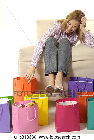 View of a young woman with colorful shopping bags placed in front of her. View Large Photo Image Stock Image - View of a young woman with colorful shopping bags placed in front of her.. Fotosearch