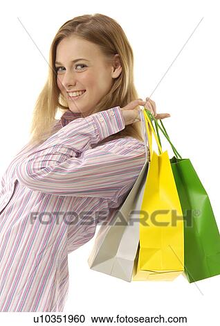 View of an attractive woman holding shopping bags. View Large Photo Image Stock Image - View of an attractive woman holding shopping bags.. Fotosearch