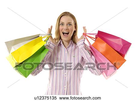 View of an excited young woman holding bags. View Large Photo Image Stock Photography - View of an excited young woman holding bags.. Fotosearch