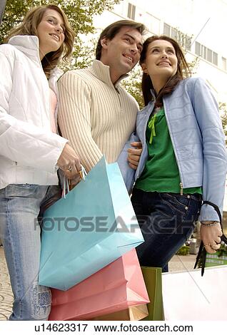 View of three friends standing together. View Large Photo Image Stock Photo - View of three friends standing together.. Fotosearch