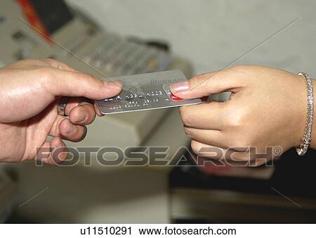 View of two people holding a credit card. View Large Photo Image Stock Image - View of two people holding a credit card.. Fotosearch