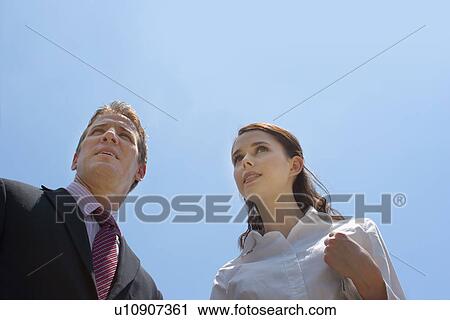 Stock Image - A Pair of Office Workers, Low Angle View, Head and Shoulders. Fotosearch