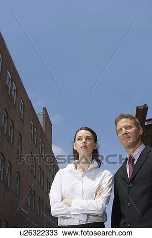A Pair of Office Workers Standing in a City, Low Angle View, Front View, Waist Up View Large Photo Image Stock Image - A Pair of Office Workers Standing in a City, Low Angle View, Front View, Waist Up. Fotosearch
