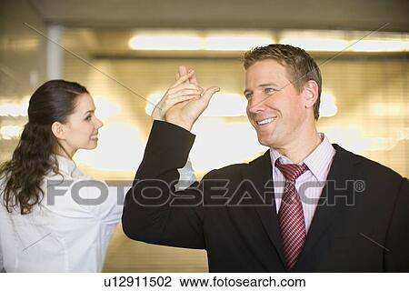 A Pair of Office Workers Touching Each Other's Hands, Front View, Rear View, Head and Shoulders, Differential Focus View Large Photo Image Stock Image - A Pair of Office Workers Touching Each Other's Hands, Front View, Rear View, Head and Shoulders, Differential Focus. Fotosearch