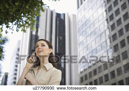 A Young Adult Businesswoman Talking on the Cellular Phone, Head and Shoulders, Low Angle View View Large Photo Image Stock Image - A Young Adult Businesswoman Talking on the Cellular Phone, Head and Shoulders, Low Angle View. Fotosearch