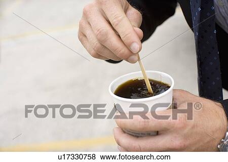Closed Up Image of a Hands Stirring Coffee, High Angle View, Differential Focus View Large Photo Image Stock Photo - Closed Up Image of a Hands Stirring Coffee, High Angle View, Differential Focus. Fotosearch