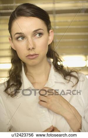 Stock Photograph - Portrait of a Young Adult Businesswoman, Front View, Differential Focus, Head and Shoulders. Fotosearch