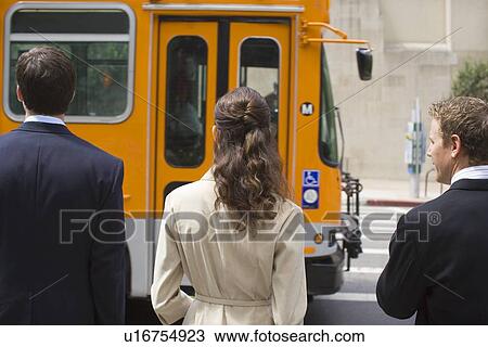 Stock Image - Three Office Workers at the Pedestrian Crossing, Rear View, Waist Up. Fotosearch