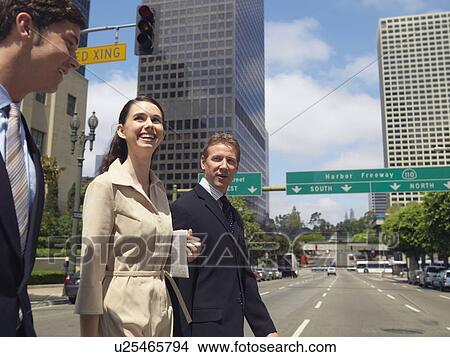 Three Smiling Office Workers Walking the Downtown, Waist Up View Large Photo Image Picture - Three Smiling Office Workers Walking the Downtown, Waist Up. Fotosearch