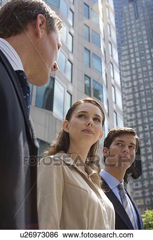 Three Talking Office Workers, Low Angle View, Waist Up View Large Photo Image Stock Photograph - Three Talking Office Workers, Low Angle View, Waist Up. Fotosearch
