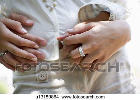 Picture - Couple's Hands, Close Up, Differential Focus. Fotosearch