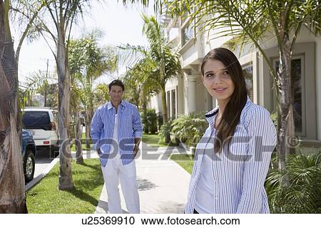 Young adult couple standing on pavement, Front View, Side View View Large Photo Image Stock Image - Young adult couple standing on pavement, Front View, Side View. Fotosearch