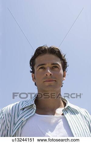 Young adult man looking away, Low Angle View View Large Photo Image Stock Image - Young adult man looking away, Low Angle View. Fotosearch