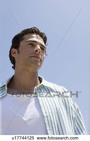 Young adult man looking away, Low Angle View View Large Photo Image Stock Photography - Young adult man looking away, Low Angle View. Fotosearch