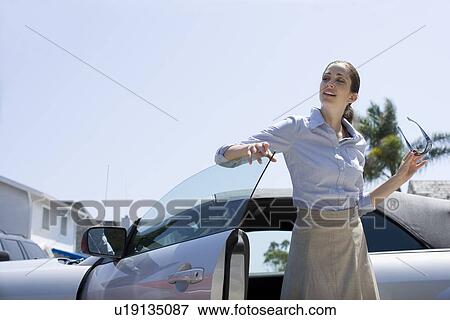Young adult woman getting out of a car, Side View View Large Photo Image Stock Photo - Young adult woman getting out of a car, Side View. Fotosearch