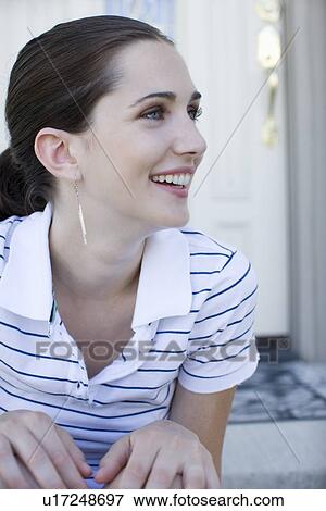 Young adult woman sitting on stairs and smiling, High Angle View View Large Photo Image Stock Photo - Young adult woman sitting on stairs and smiling, High Angle View. Fotosearch