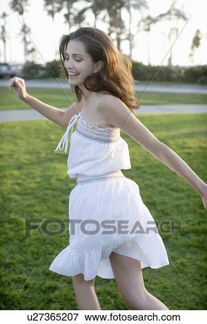 Young adult woman smiling and running, Rear View, Side View, Differential Focus View Large Photo Image Stock Photo - Young adult woman smiling and running, Rear View, Side View, Differential Focus. Fotosearch