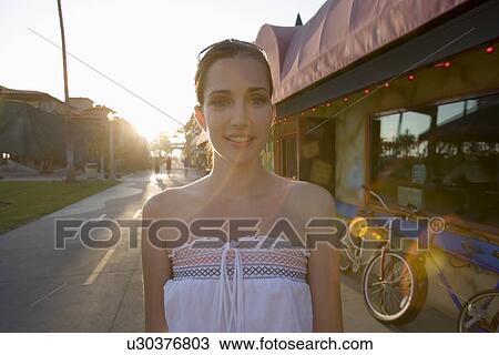 Young adult woman smiling at camera, Front View, Lens Flare View Large Photo Image Stock Image - Young adult woman smiling at camera, Front View, Lens Flare. Fotosearch