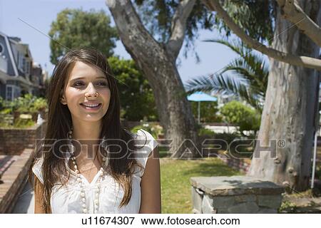 Young adult woman smiling, Front View, Differential Focus View Large Photo Image Stock Photo - Young adult woman smiling, Front View, Differential Focus. Fotosearch