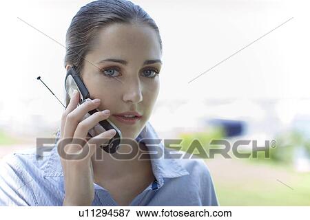 Young adult woman talking on mobile phone, Front View, Differential Focus View Large Photo Image Stock Photo - Young adult woman talking on mobile phone, Front View, Differential Focus. Fotosearch