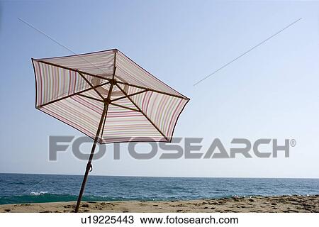 Beach parasol on beach, Low Angle View, Copy Space View Large Photo Image Stock Image - Beach parasol on beach, Low Angle View, Copy Space . Fotosearch