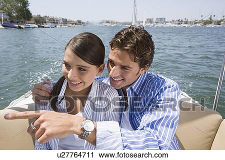 Stock Image - Young adult couple on a cruiser, High Angle View, Differential Focus. Fotosearch