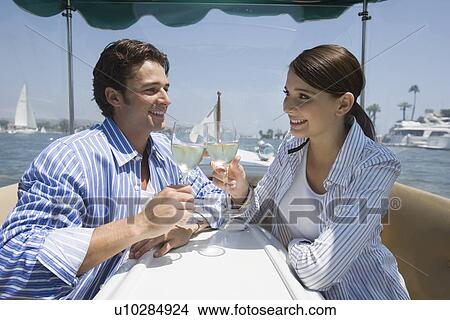Young adult couple on a cruiser toasting with wine, Side View, Differential Focus View Large Photo Image Picture - Young adult couple on a cruiser toasting with wine, Side View, Differential Focus. Fotosearch