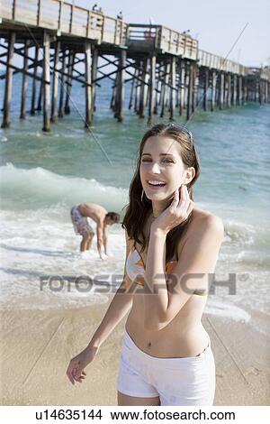 Picture - Young adult couple on beach, Front View, Side View, Differential Focus. Fotosearch