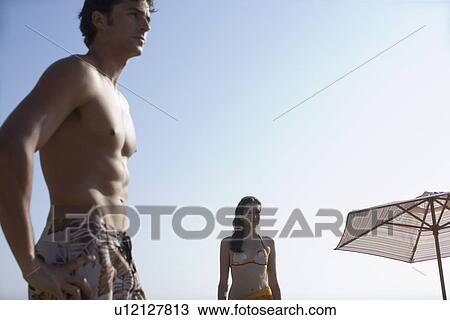 Young adult couple on beach, Front View, Side View, Low Angle View, Copy Space View Large Photo Image Stock Image - Young adult couple on beach, Front View, Side View, Low Angle View, Copy Space . Fotosearch