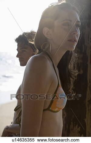 Young adult couple on beach, Side View, Differential Focus, Lens Flare View Large Photo Image Stock Photography - Young adult couple on beach, Side View, Differential Focus, Lens Flare. Fotosearch