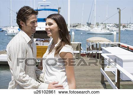 Young adult couple on pier, Side View View Large Photo Image Stock Image - Young adult couple on pier, Side View. Fotosearch