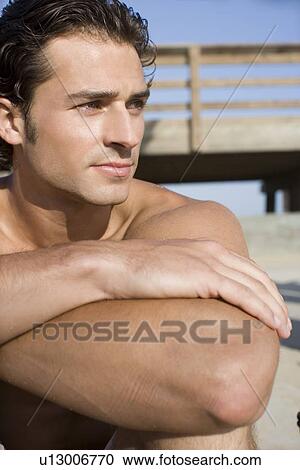 Young adult man looking away on beach, Side View, Front View, Differential Focus View Large Photo Image Stock Image - Young adult man looking away on beach, Side View, Front View, Differential Focus. Fotosearch