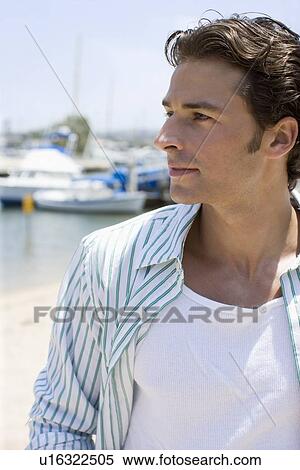 Young adult man looking away, Side View, Differential Focus View Large Photo Image Stock Photography - Young adult man looking away, Side View, Differential Focus. Fotosearch