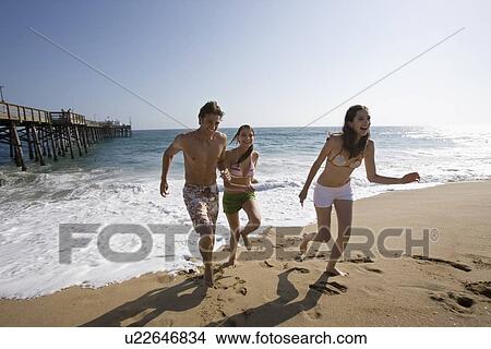 Young adult people running on beach, Front View View Large Photo Image Picture - Young adult people running on beach, Front View. Fotosearch