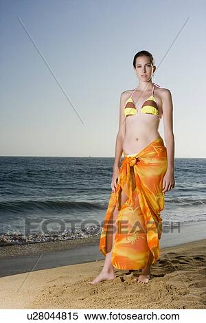 Young adult woman in bikini standing on beach, Front View, Copy Space View Large Photo Image Stock Photography - Young adult woman in bikini standing on beach, Front View, Copy Space . Fotosearch
