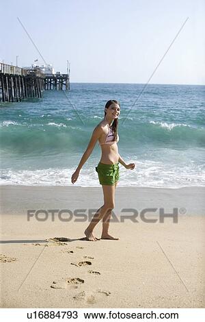 Young adult woman in bikini walking on beach, Side View View Large Photo Image Stock Image - Young adult woman in bikini walking on beach, Side View. Fotosearch