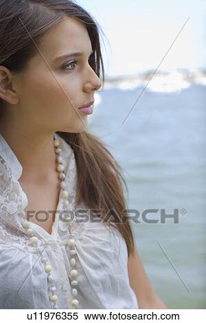 Young adult woman looking away, Side View, Differential Focus View Large Photo Image Stock Photography - Young adult woman looking away, Side View, Differential Focus. Fotosearch