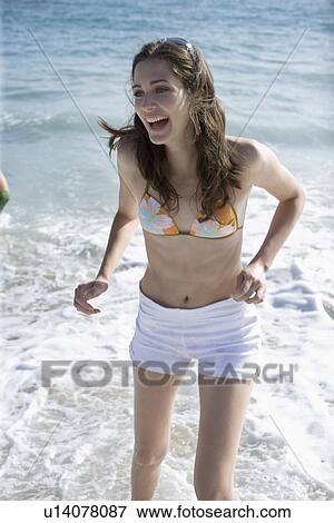 Stock Photo - Young adult woman smiling and bathing, High Angle View. Fotosearch