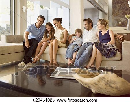 Happy people on the sofa View Large Photo Image Stock Image - Happy people on the sofa. Fotosearch - Search Stock Photos, Mural Pictures, Photographs, and Photo Clipart