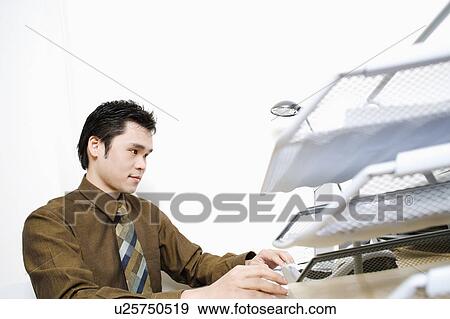 Businessman using a laptop View Large Photo Image Stock Photo - Businessman using a laptop. Fotosearch